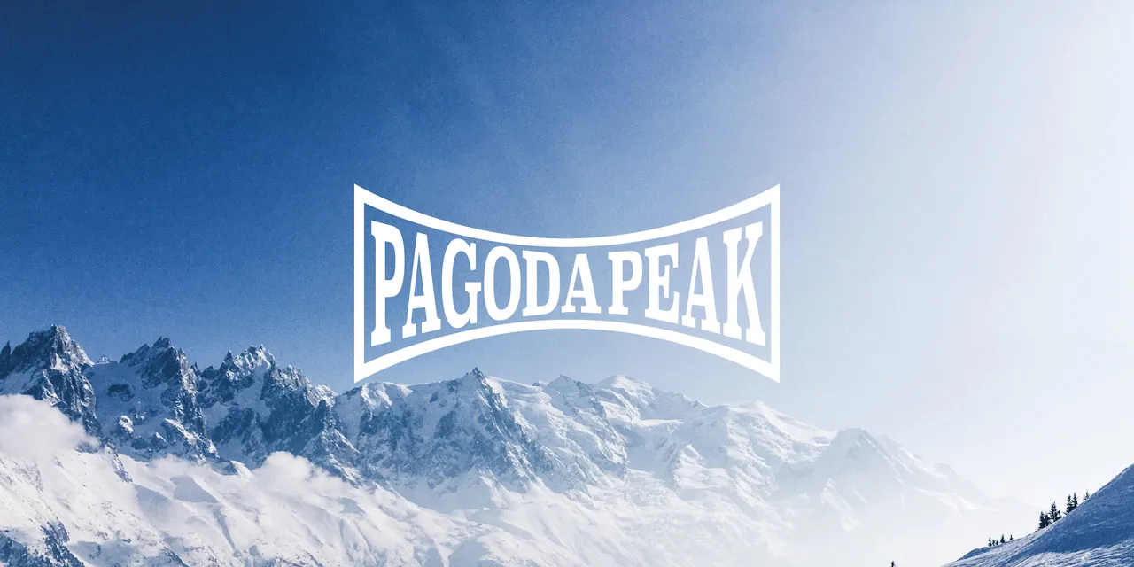 Pagoda Peak wordmark logo on a blue sky with snow covered mountain peaks in the distance